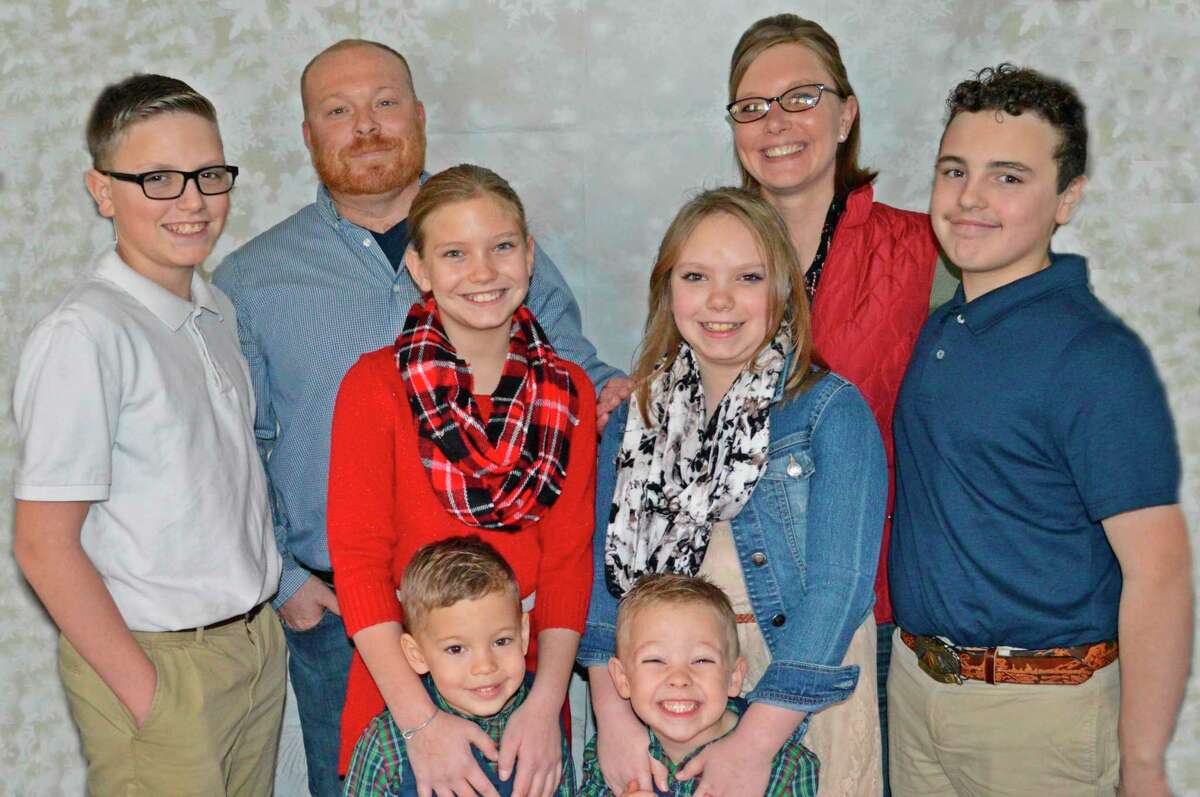 Joni Palmer, back right, with her husband Kyle, back left, and their children, Chase, left, Harley, second from left, Isabelle, second from right, Kaden, right, Hudson, bottom left, and Henry, bottom right. (Photo provided)