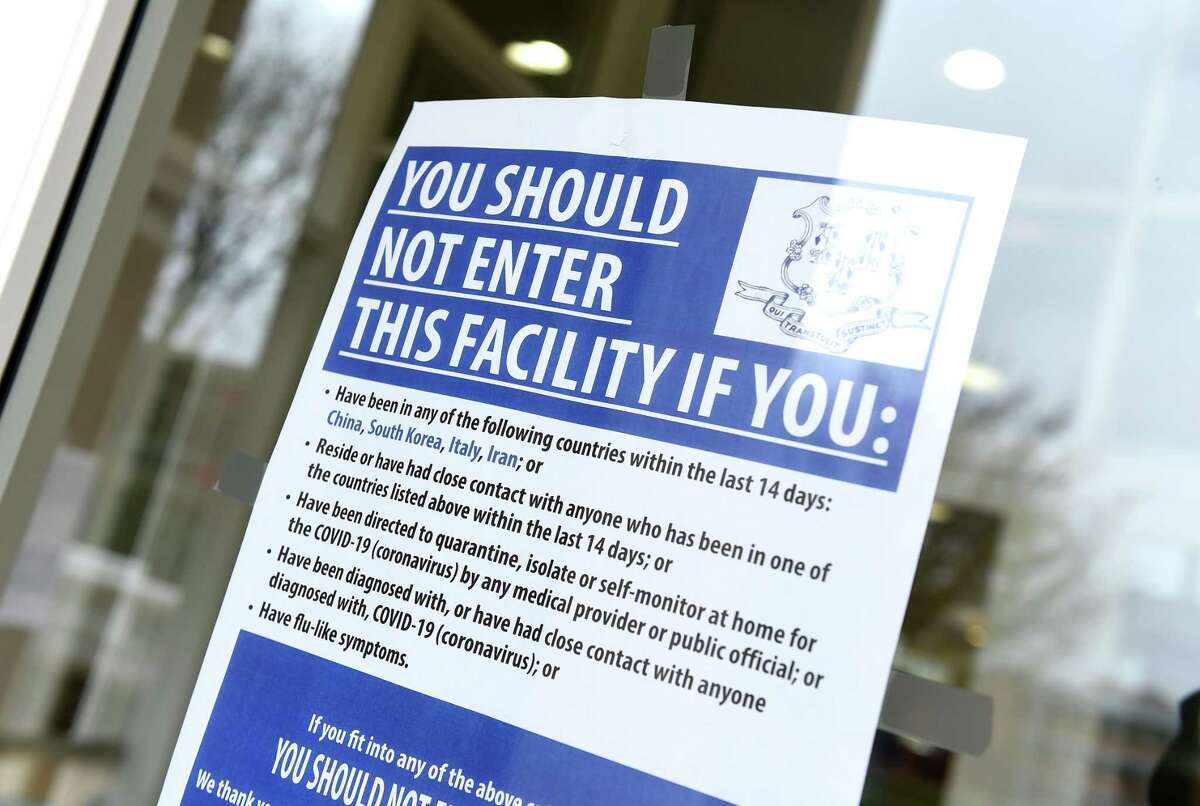 A dated sign hangs in the entrance to the Michael J. Adanti Student Center on a deserted Southern Connecticut State University campus in New Haven on Monday.