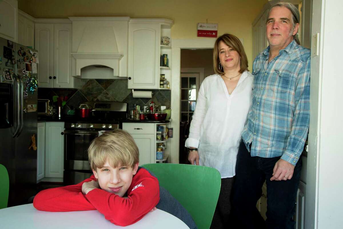 Isaac Heider, 12, sits in the kitchen table with his parents, Carol and Clinton, as they continue to ride out the shelter in place measures due to the coronavirus on Tuesday, April 14, 2020 in Houston. COVID-19 is the latest in a string of major events that have affected young children during the past few years, following Harvey and Imelda. The Heiders were flooded out of their Meyerland home during Harvey.