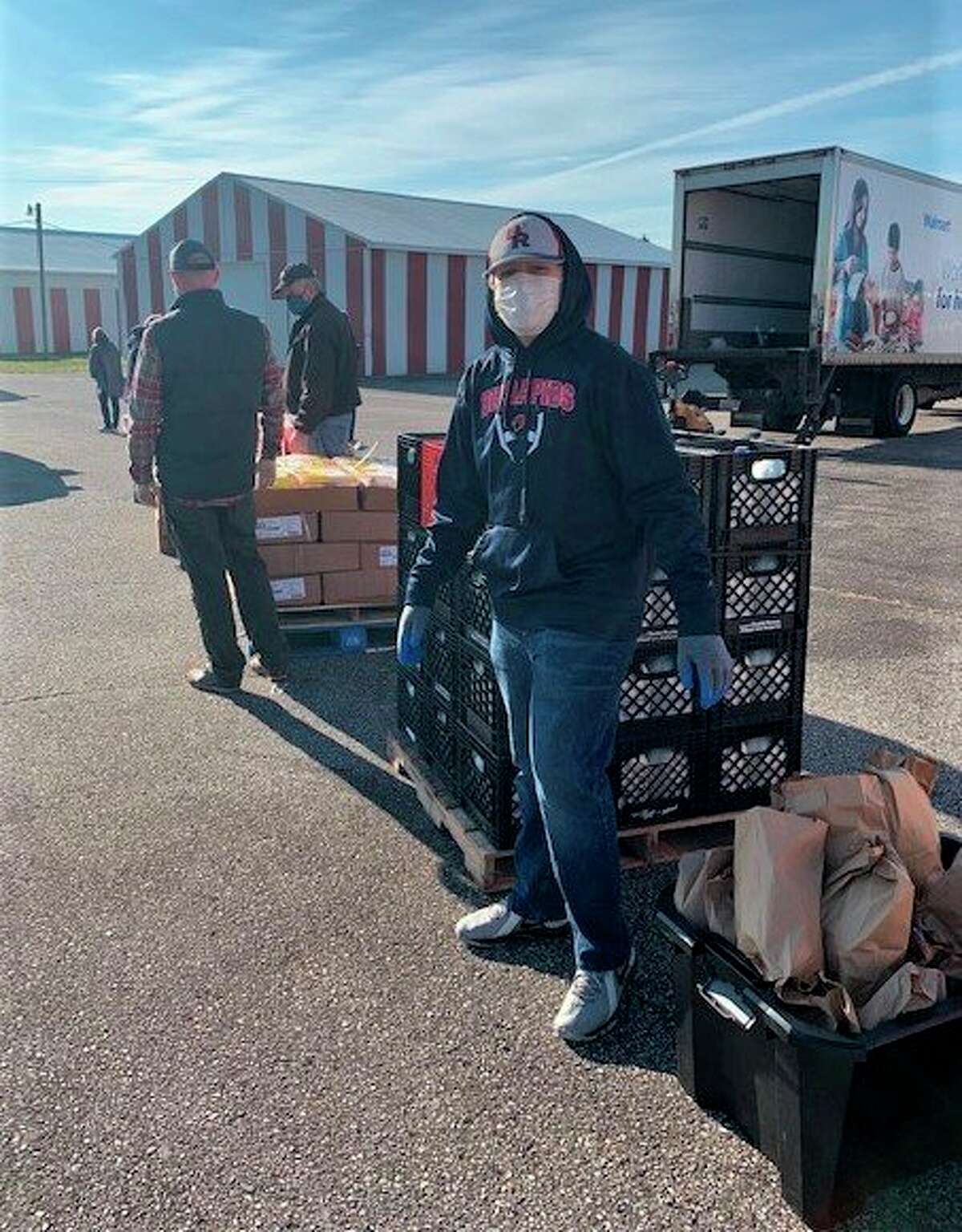 As well as asking guests to remain in their vehicle during the mobile pantry event, volunteers wore face masks as they distributed the bags of food to the cars. (Courtesy photo)