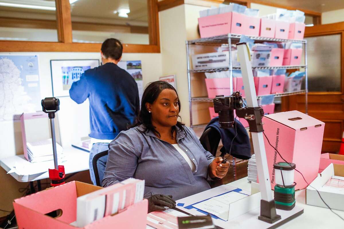 Dee McCardell aids in sorting mail-in ballots following the elections yesterday at the Department of Elections at City Hall in San Francisco, California, on Wednesday, Nov. 6, 2019.