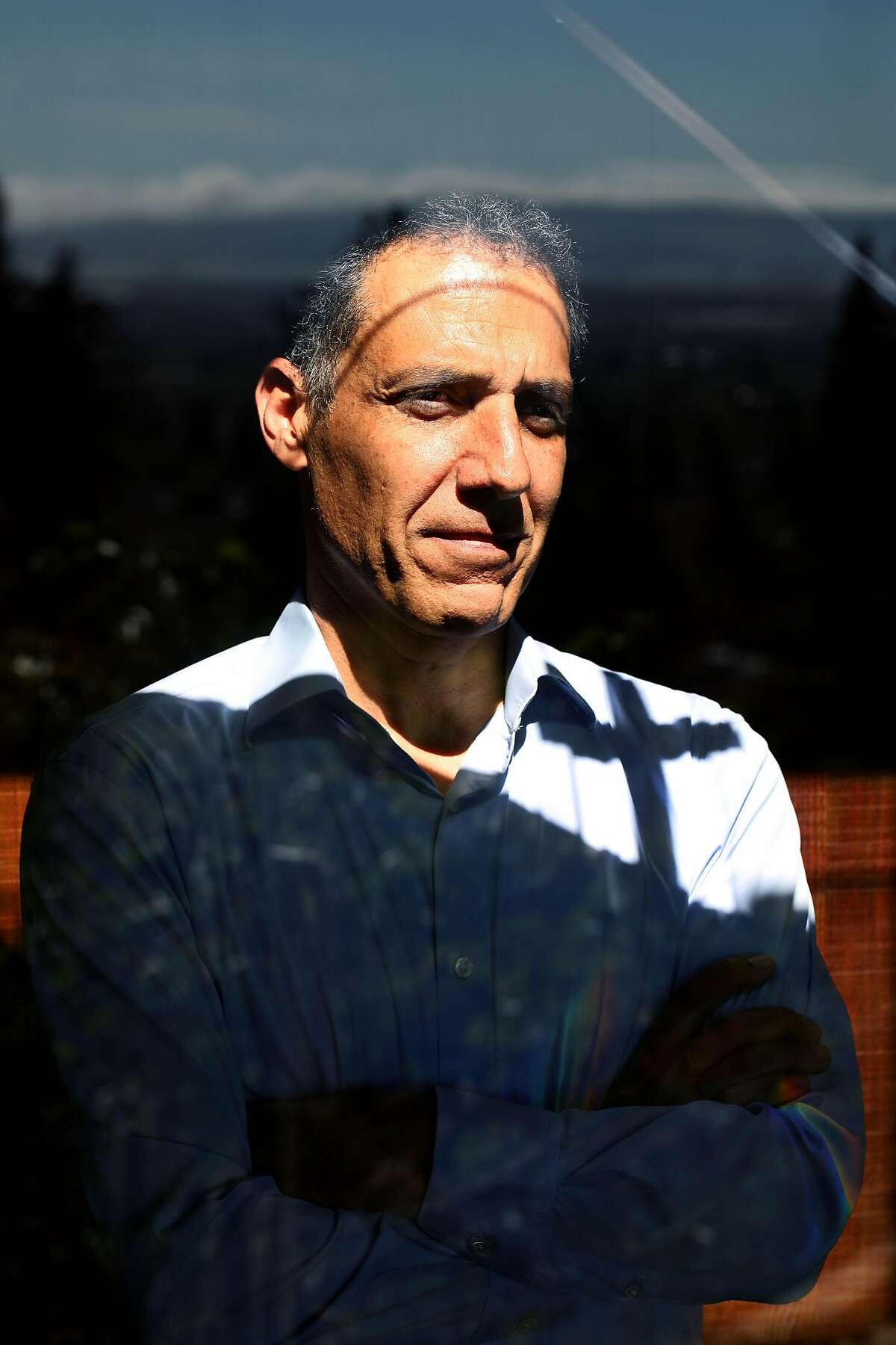 Professor Hany Farid poses for a portrait in his home on Wednesday, April 22, 2020, in Berkeley, Calif. Prof. Farid is doing a huge survey related to conspiracies and the coronavirus. He's done work with Facebook and Twitter in the past to combat this kind of thing.