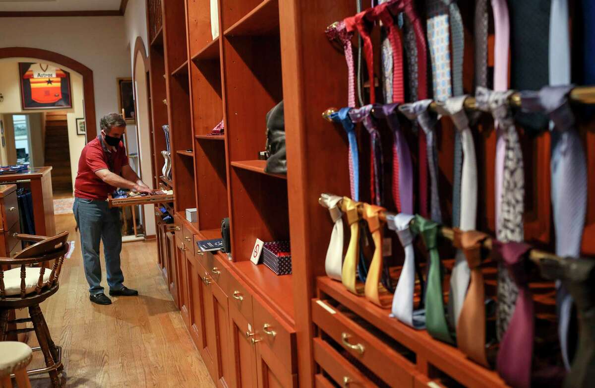 Ali Taghi, co-owner of A Taghi Fine Apparel & Shoes, organizes the store ahead of a planned reopening Tuesday, April 28, 2020, in Houston. Governor Greg Abbott decided to allow some businesses to open at reduced capacity Friday, overruling local leaders. The Taghi brothers, who own the store, said they plan to have a sale when they re-open, and that they plan to donate a portion of the profits to vaccine researchers.