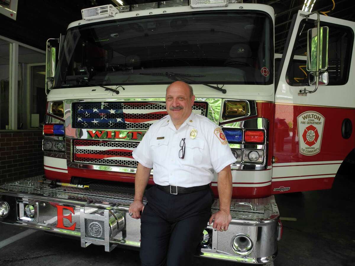 Former Wilton Fire Chief Ron Kanterman rests on Engine 1 at the Wilton, Conn., firehouse on June 25, 2019. He served Wilton for five years.