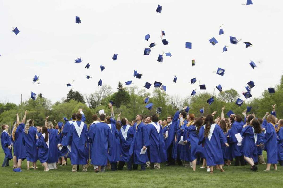 Seniors in the Morley Stanwood High School class of 2018 throw their caps in the air during their graduation ceremony.