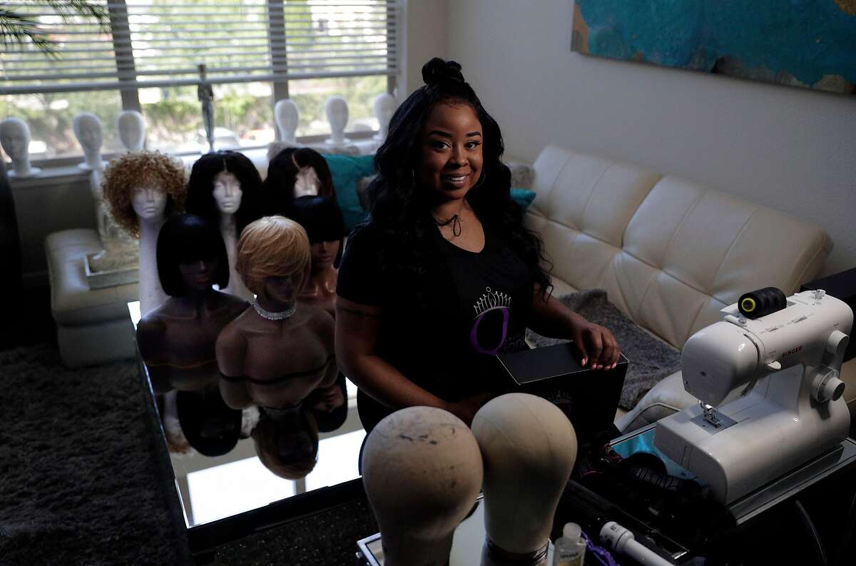 Qiana Newton, owner of House of Qiana, in her home in Tracy, Calif., on Sunday, April 26, 2020, where she has been hand making wigs. Newton found that after her salon space closed because of the Covid-19 pandemic, customers were looking to maintain their looks and for some, it was an opportunity to go natural, try a wig or become their own stylist. Newton’s been making and styling wigs and selling them online as a form of income during the shutdown. Her new wig business is outgrowing her former space, and other than styling wigs at home she also makes beauty products--Qbutter (hair and body cream) and Magic drops (hair growth serum).