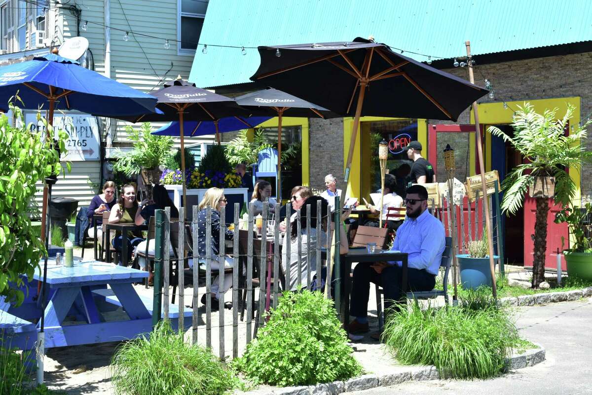 Diners enjoy a sunny noon hour in May 2018, at the outdoor patio of Valencia Luncheria on Main Street in Norwalk, Conn.