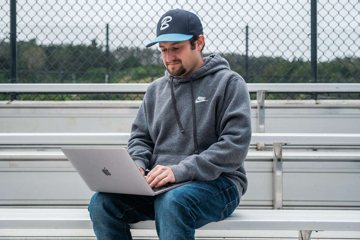 Daniel Rathman is seen withhis computer while hanging out at Paul Goode baseball field in San Francisco, Calif. on Thursday April 16, 2020. Rathman plays fantasy baseball which has been shut down just like real baseball amid COVID.