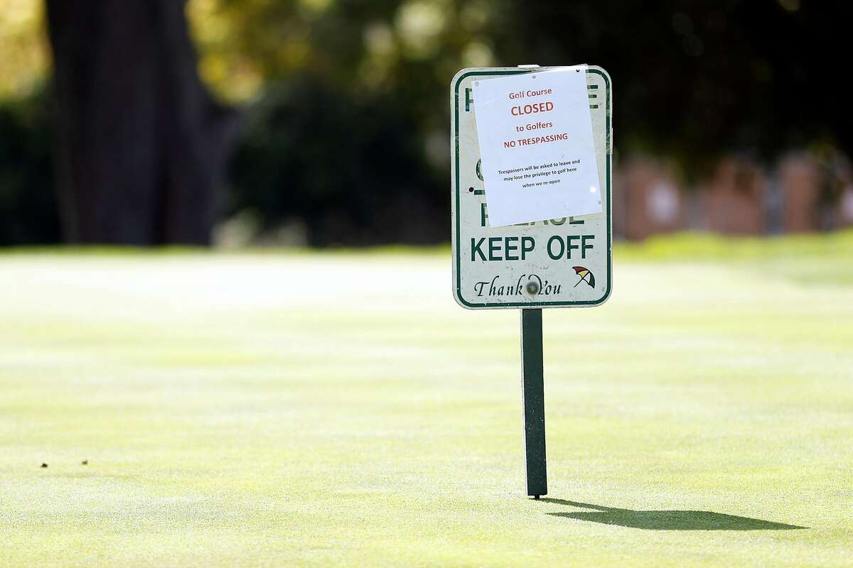 A closed sign on a green at Presidio Golf Course in San Francisco, Calif., on Monday, March 30, 2020.