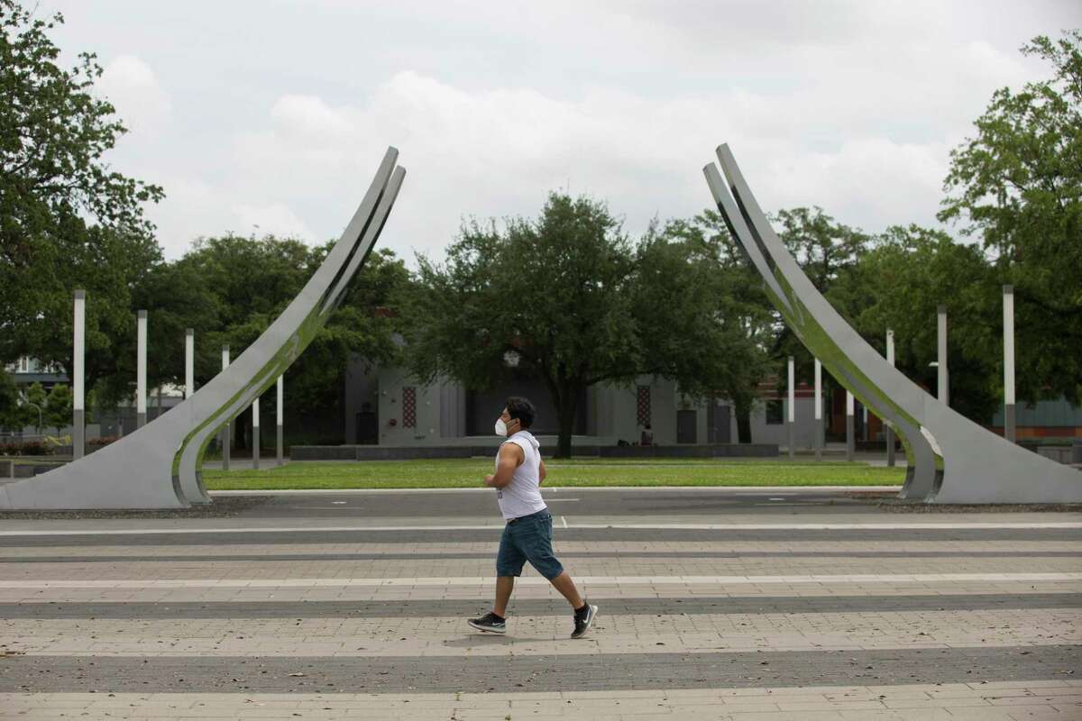 A man runs around Emancipation Park with a face mask on April 17, 2020, in Houston.