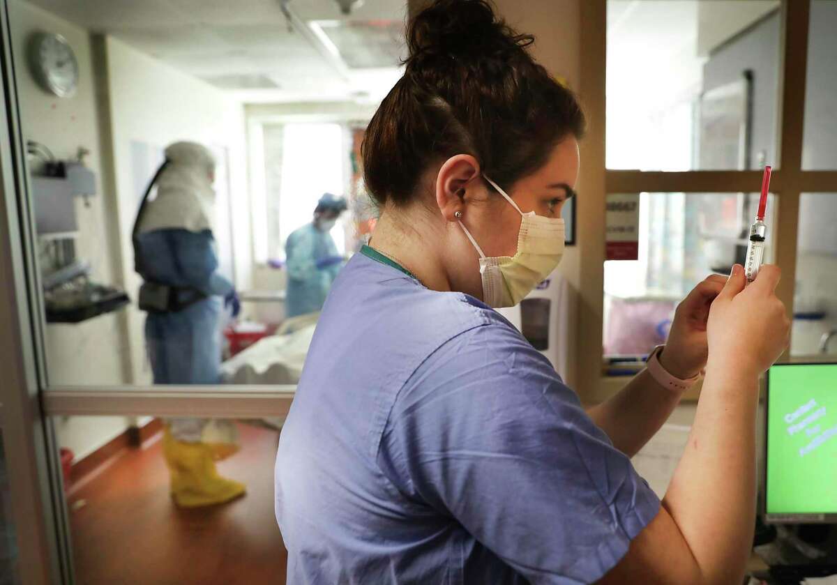 A nurse in the Methodist Hospital Covid Unit checks medicine for a patient as doctors prepare to intubate a patient, on Thursday, April 23, 2020.