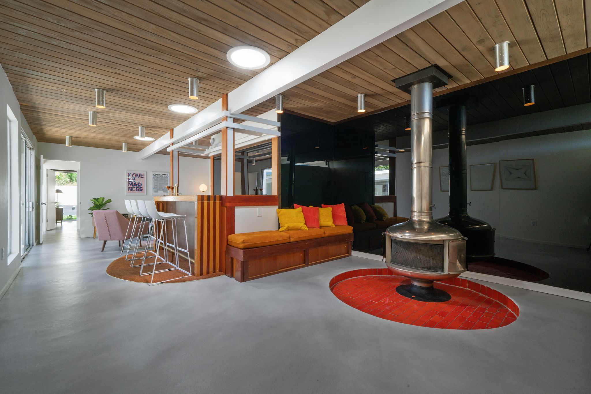 The property was originally built as a five-bedroom home. One bedroom and the garage have since been converted into an entertainment space with custom wet bar, sunken lounge area with built-in seating, a floating steel fireplace and period lighting throughout.