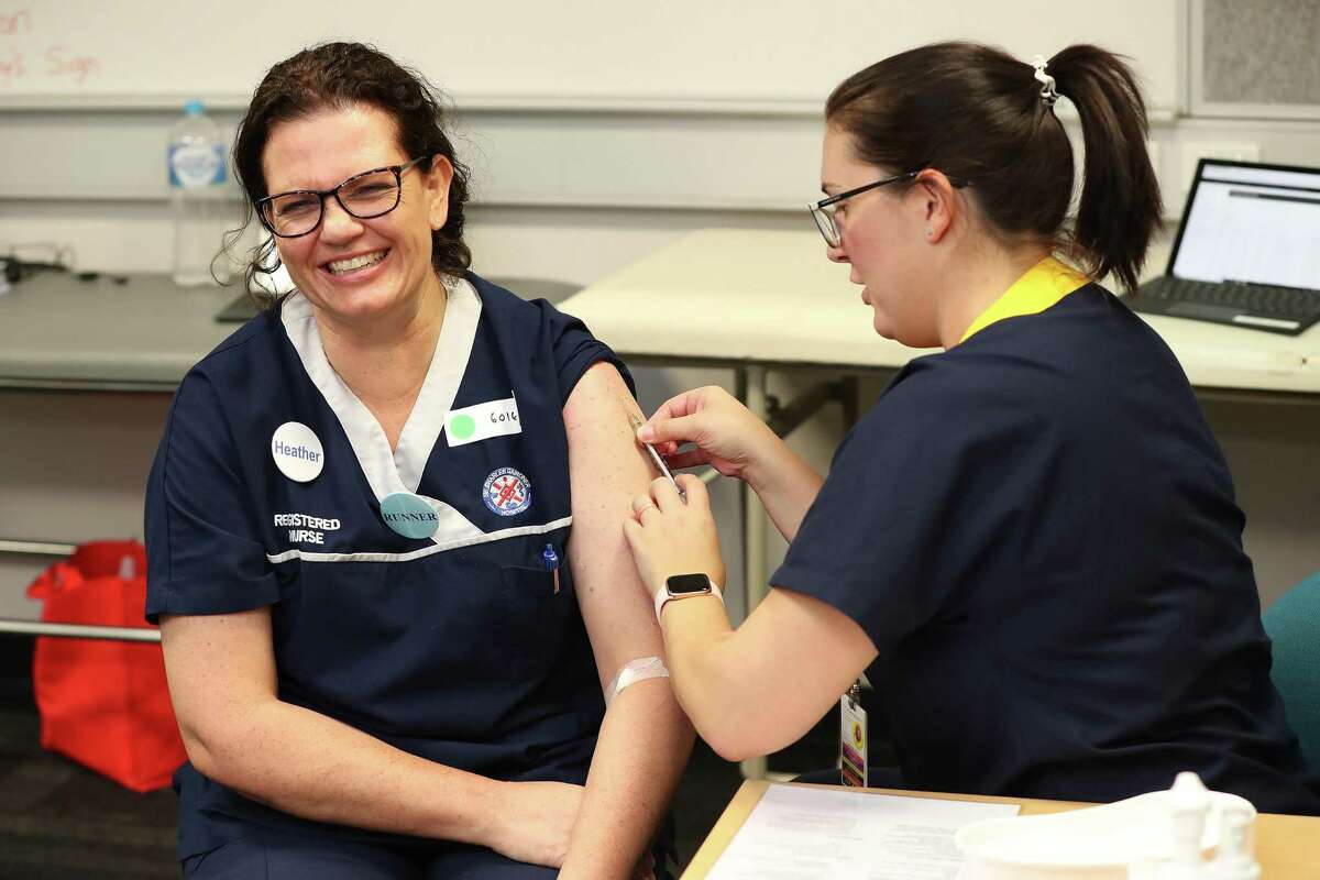 PERTH, AUSTRALIA - APRIL 20: Registered nurse Heather Hoppe receives a BCG injection in the trial clinic at Sir Charles Gairdner hospital on April 20, 2020 in Perth, Australia. Healthcare workers in Western Australia are participating in a new trial to test whether an existing tuberculosis vaccine can help reduce their chances of contracting COVID-19. 2000 frontline staff from Fiona Stanley, Sir Charles Gairdner and Perth Children's Hospital are taking part in the research trial, which will see half of participants receiving the existing Bacillus Calmette-Guérin (BCG) vaccine in addition to their flu vaccine, while the other half receive the regular flu shot. The BCG vaccine was originally developed to work against tuberculosis, but it is hoped it might help reduce the chance of contracting coronavirus as well as lessen the severity of symptoms and boost immunity in the long term. The BRACE trial is being led by by the Murdoch Children's Research Institute. (Photo by Paul Kane/Getty Images)