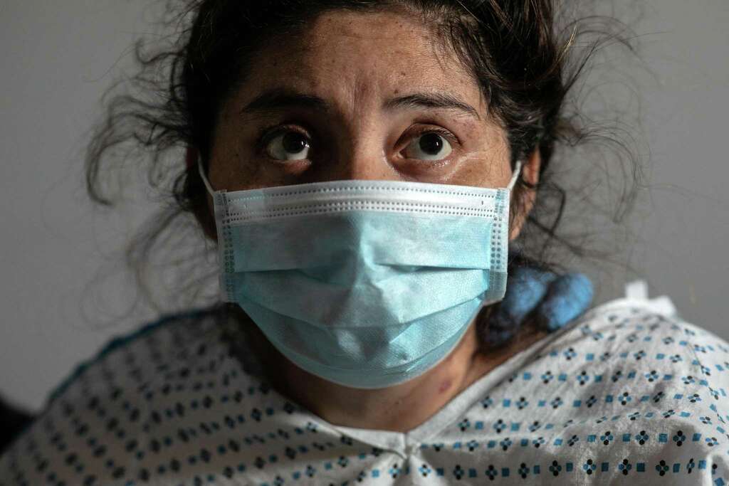 <p>COVID-19 patient and Guatemalan asylum seeker Zully sits on her bed after arriving home by ambulance from Stamford Hospital on April 25, 2020 in Stamford, Connecticut. She had first gone to the hospital gravely</p>