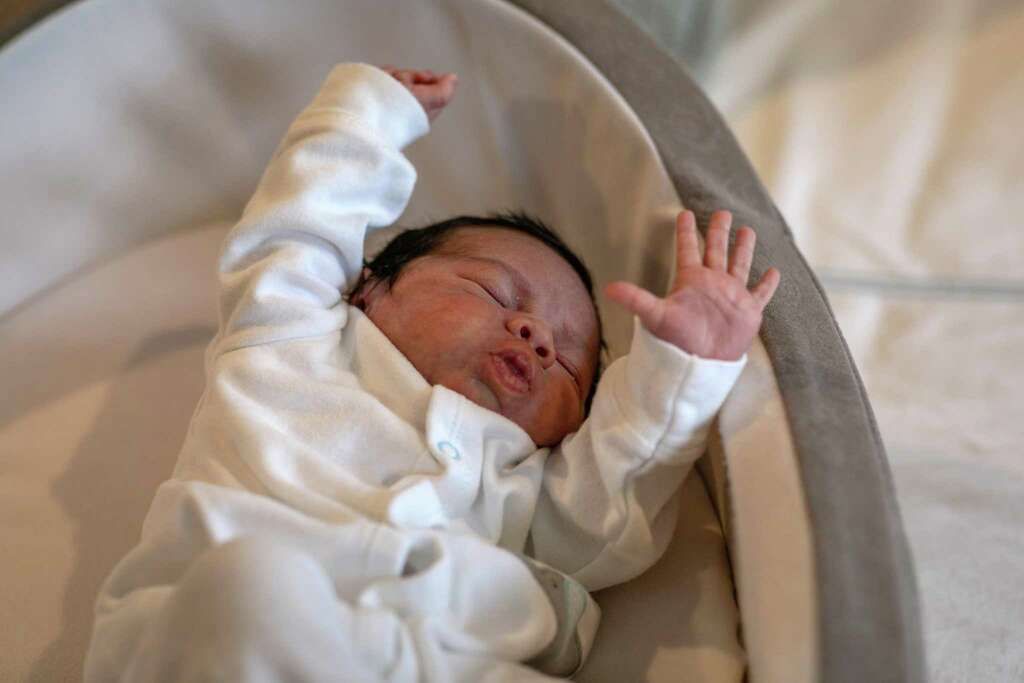 <p>Baby Neysel, then 2 1/2 weeks, stretches in a bassinet at Luciana Lira's home on April 20, 2020 in Stamford, Connecticut. Lira, a K-5 Bilingual /ESL teacher at Hart Magnet Elementary in Stamford, became</p>
