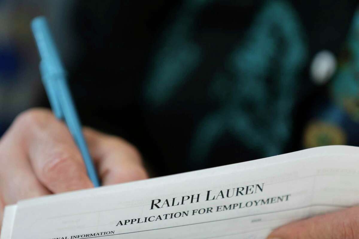 A job seeker fills out a job application during a job fair in Miami in this file photo.