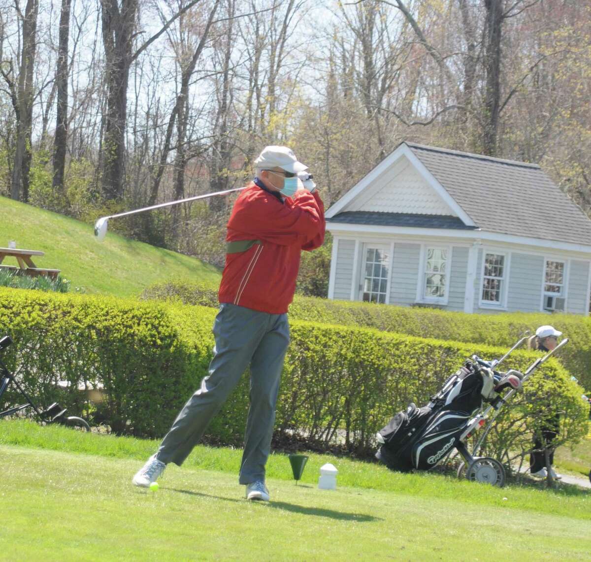 A masked golfer on the first tee Tuesday, when Ridgefield's golf course reopened.