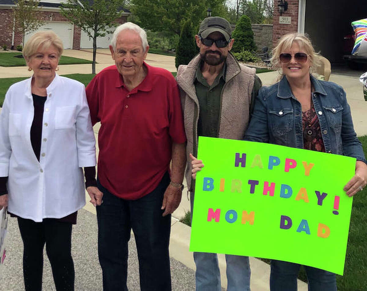 Left to right, Joan Flake, Dean Flake, son-in-law Bob Flake and daughter Tam Flake celebrate Joan and Dean’s shared birthday on Monday. Joan turned 82 and Dean turned 83, and a parade of about 30 cars drove past the Traws’ Edwardsville home to mark the occasion.