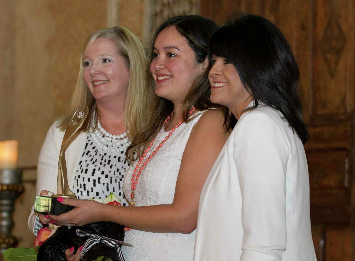 Christina Tejeda Cervantez, daughter of Marlen Tejada, accepts the Athena Leadership Award on behalf of her mother during a luncheon at Madera Estates, Thursday, July 25, 2019, in Conroe. The annual award luncheon, hosted by the Conroe/Lake Conroe Area Chamber of Commerce, recognized several women leaders in Montgomery County and featured speaker Danna Hoyt, president of Sam Houston State University.
