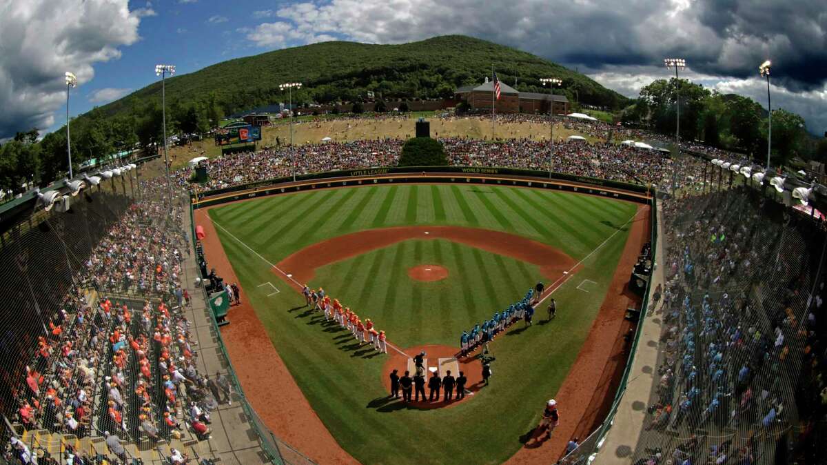 In this Sunday, Aug. 25, 2019, file photo, River Ridge, Louisiana, lines the third baseline and Curacao lines the first baseline during team introductions before the Little League World Series Championship game at Lamade Stadium in South Williamsport, Pa. The 2020 Little League World Series and the championship tournaments in six other Little League divisions have been canceled because of the new coronavirus pandemic.