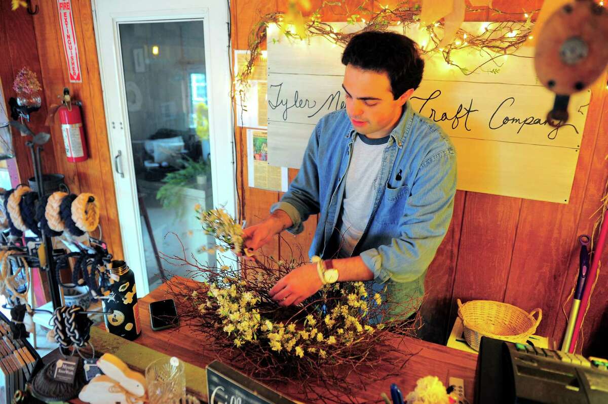 Tyler Newkirk prepares a wreath at his gift shop at B&B Farm in West Haven April 29, 2020.