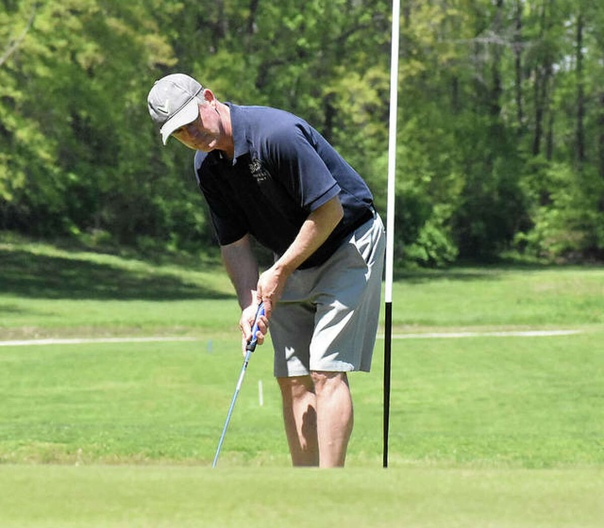 Edwardsville resident Dave Wasmuth reacts to his putt on the No. 9 hole at Oak Brook Golf Club on Friday.