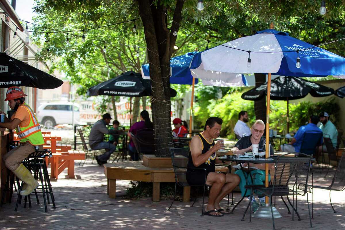 Patrons eat outside on the patio at Earl Abel's on May 1, 2020. Earl Abel's is reopening for patio-only table service following restrictions on restaurants being lifted by Gov. Greg Abbott.