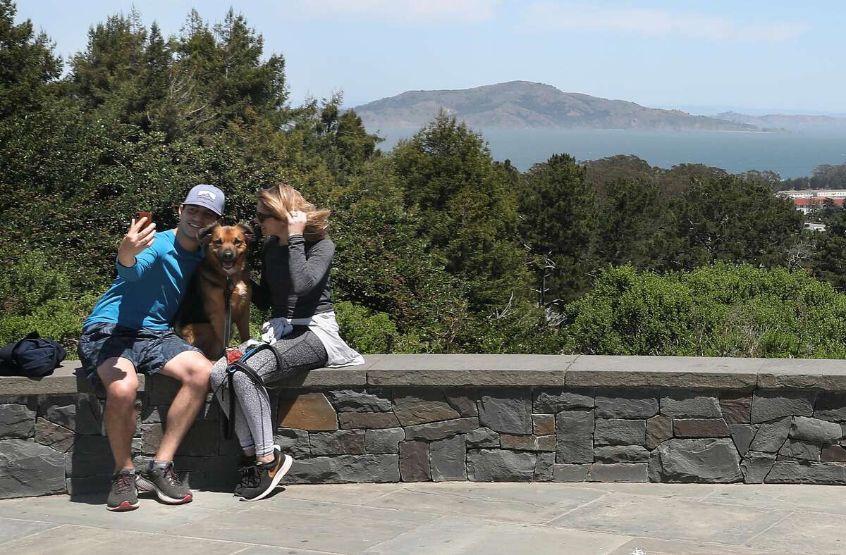 Sean Lewis (left) and Shanna Wagnor (right) like walking their dog Frankie to lnspiration Point at the Presidio on Thursday, April 30, 2020, in San Francisco, Calif.