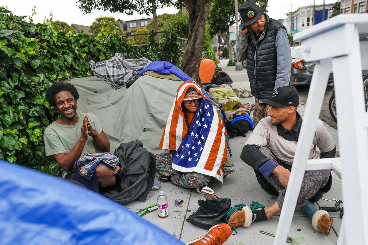Homeless men gather at a tent encampment on Oak Street on Sunday, April 19, 2020 in San Francisco, California.