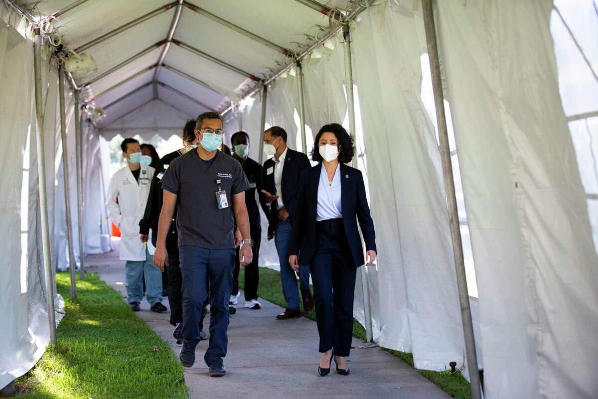 Harris County Judge Lina Hidalgo and medical doctor Kunal Sharma enter an area of the Lyndon B. Johnson Hospital where patients are evaluated for COVID-19 on Thursday, April 30, 2020, in Houston.