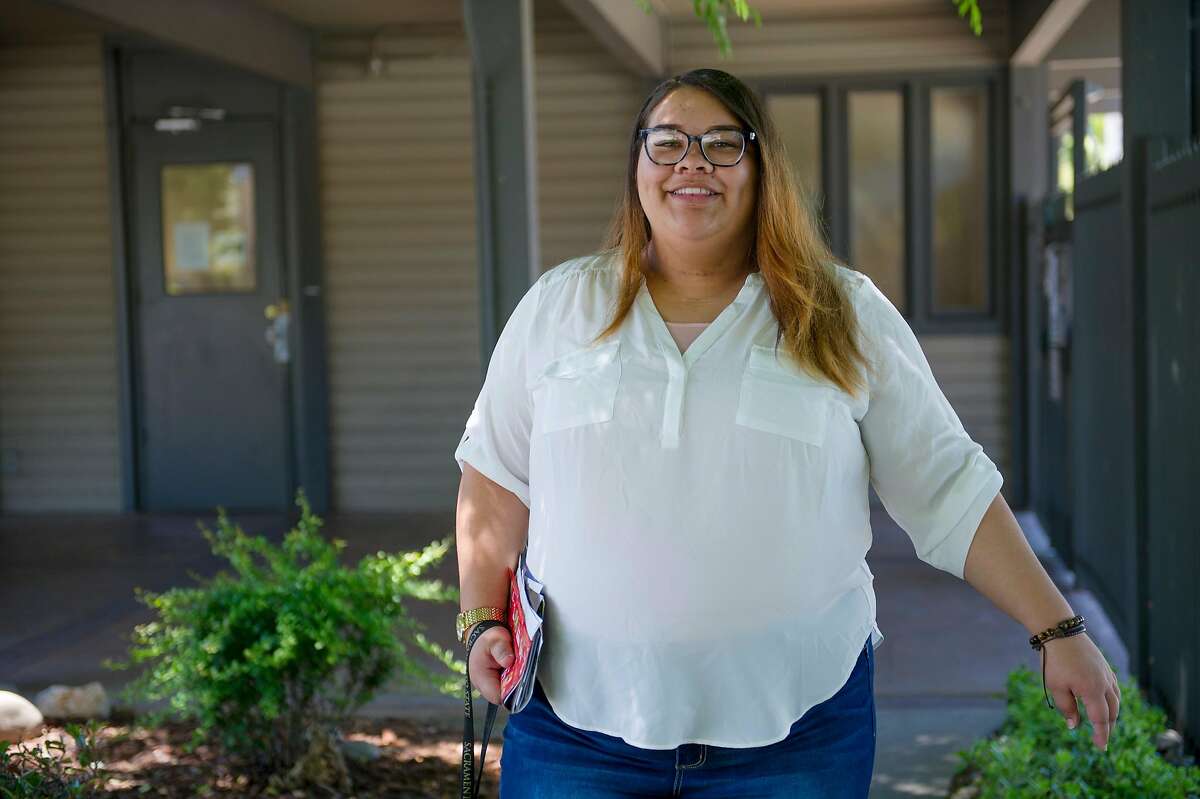 Aja Dunlap gets the mail at the apartment complex where she lives in Sacramento, Calif. on Thursday, April 30, 2020. Dunlap is a Sacramento State student who is pregnant and recently transitioned out of the foster care system.