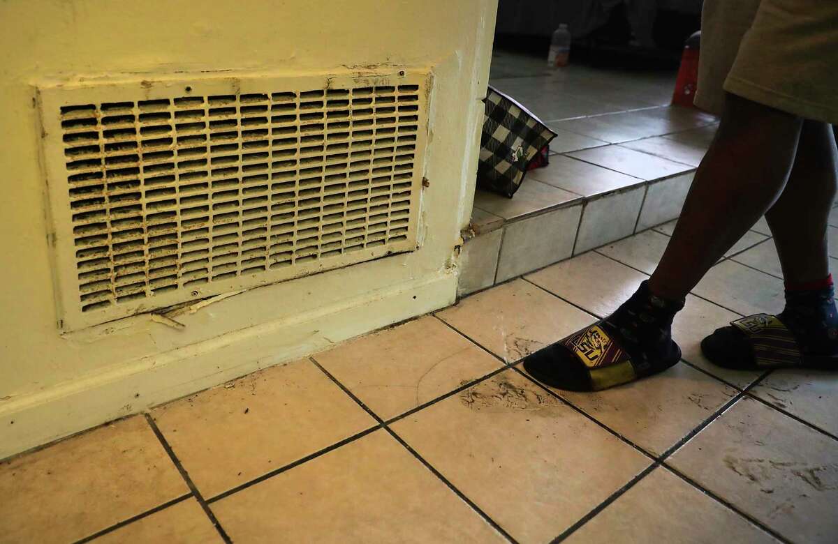 Alvin Brown, a renter at Spanish Oaks Apartments which is owned by Trif, has received a notice to vacate, on Tuesday, April 21, 2020. Brown presses his foot to show where water is coming out of the floor.