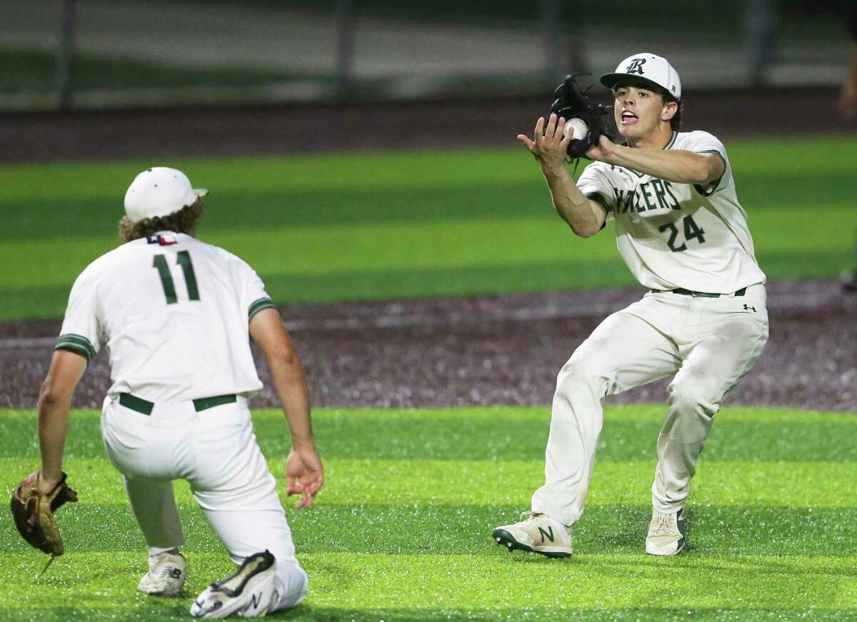 Luke Hoggart fields a high bounce grounder while Rattler pitcher Travis Sthele yields as Reagan plays Westlake in game 1 of their high school baseball playoff series ar North East Sports Park on May 16, 2019.