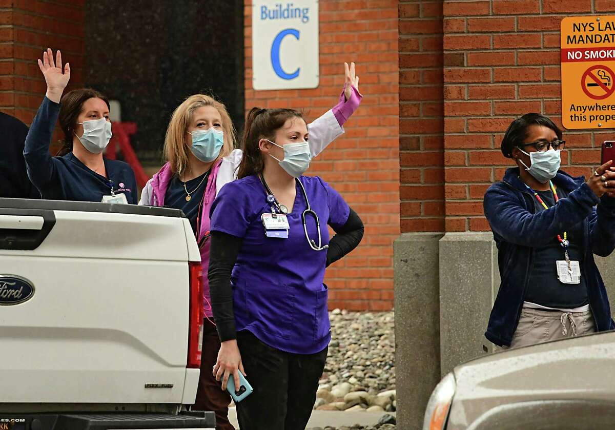 Health care workers watch as Schodack residents drive by Albany Medical Center in a parade to show gratitude and support for them on Tuesday, April 21, 2020 in Albany, N.Y. The parade also made its way past St. Peter'?•s Hospital and Albany Stratton VA Medical Center. (Lori Van Buren/Times Union)