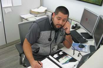 Carlos Alvarez, a nurse with Visiting Nurse & Hospice of Fairfield County, takes a call from a member of the community on April 1, 2020, as the nursing agency in Wilton, Conn., opens its Ask A Nurse hotline.