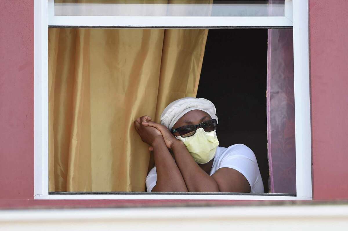 Francene Bailey sits in the window of her home in Hartford’s North End. Bailey contracted COVID-19 and is home in quarantine. Bailey is a certified nursing assistant at a nursing home in Windsor.