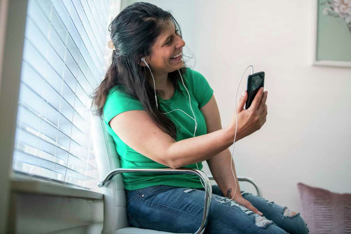 Trisha Behrens, 38, a former Bexar County detention deputy, video chats with her partner, John Garcia, who is incarcerated in the Bexar County jail after violating the terms of his parole. As the coronavirus outbreak inside the jail worsens, people like Behrens have called on the Texas Board of Pardons and Paroles to speed up the lengthy process.