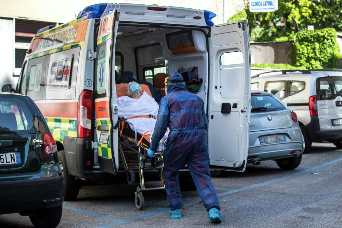 One of the hosts of residence for elderly "Clinica Latina" which resulted positive for COVID-19 is being transported to the Spallanzani hospital, after various cases of the coronavirus outbreak were discovered in this nursing home in Rome Saturday, May 2, 2020. (Roberto Monaldo/LaPresse via AP)
