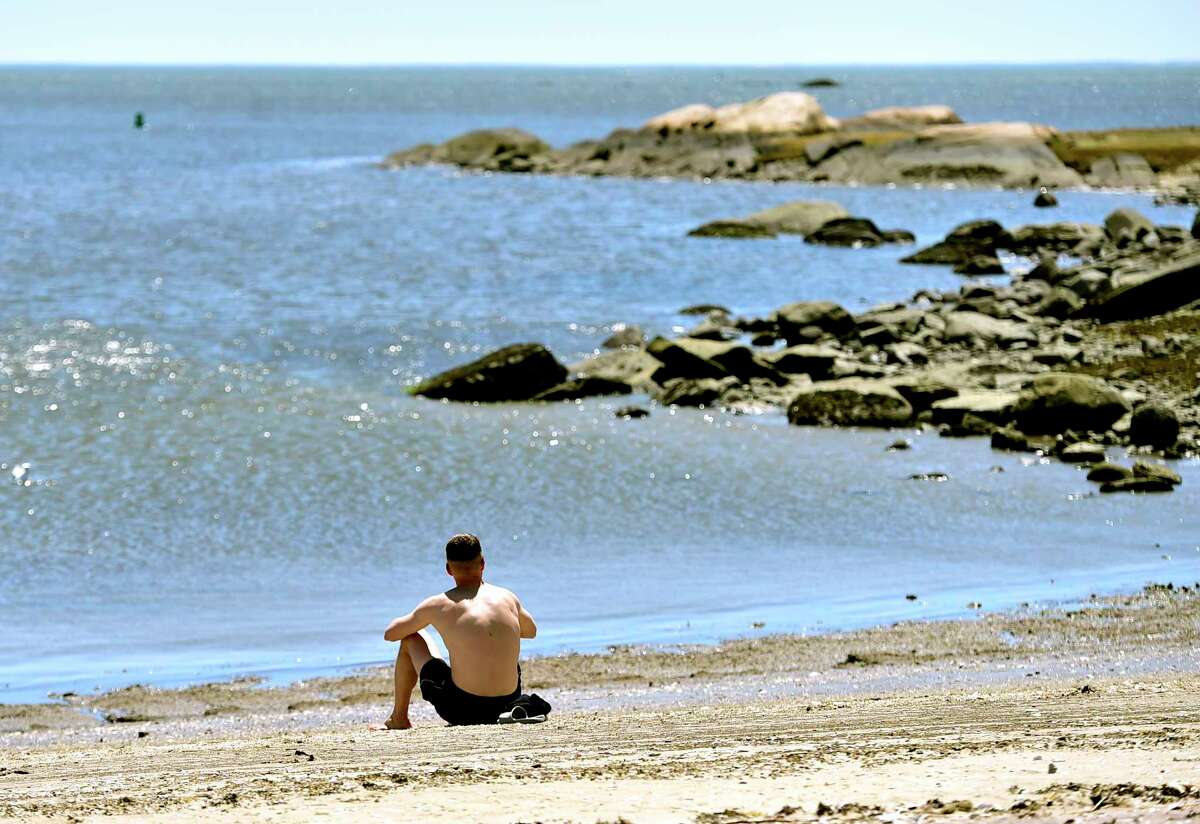 Guilford, Connecticut, Saturday, May 2, 2020: Ronald Jost of Guilford enjoys the warmth and sunshine Saturday at Jacob's Beach in Guilford during the Coronavirus / Covid-19 pandemic.