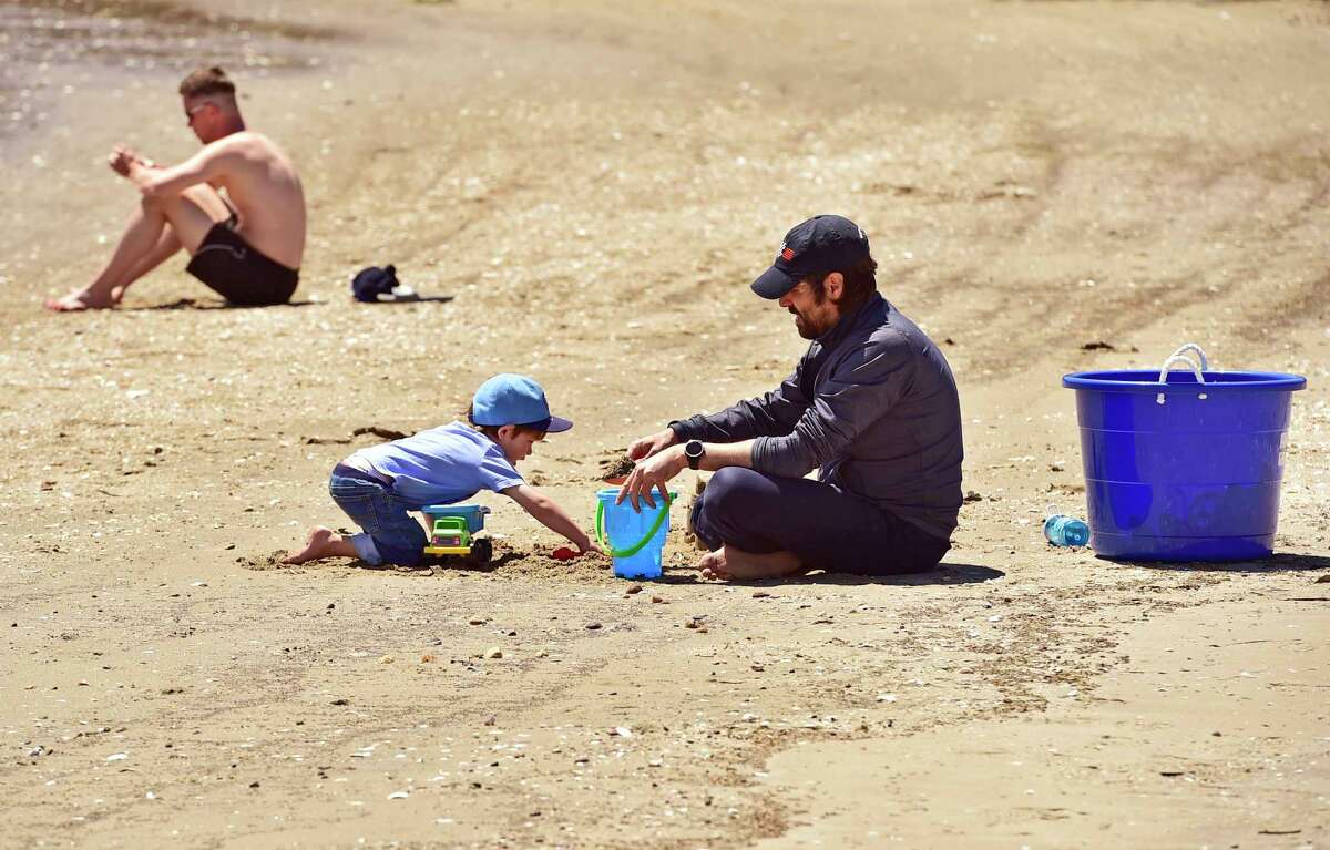 Guilford, Connecticut, Saturday, May 2, 2020: Francisco Mira of New York City and his son Max, 3, who are staying with family in Guilford due to the impact of the Coronavirus / Covid-19 pandemic on New York City, enjoy the warmth and sunshine Saturday as they play in the sand Jacob's Beach in Guilford.