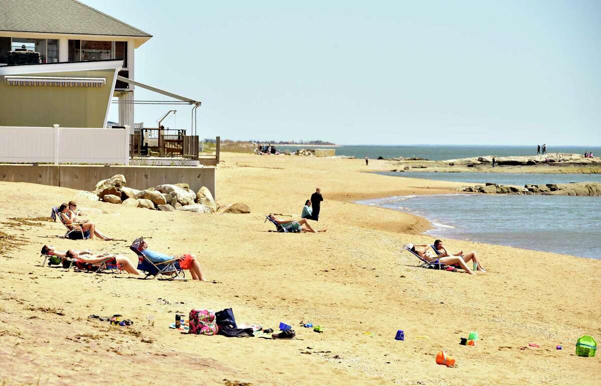 Madison, Connecticut, Saturday, May 1, 2020: People enjoy the warmth and sunshine Saturday at the Surf Club town beach in Madison during the Covid-19 / Coronavirus pandemic.