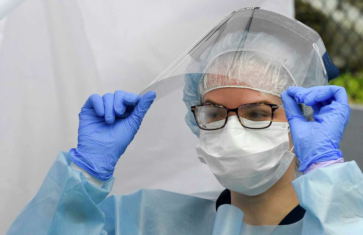 Nurse Practitioner Julianna Barresi, APRN, at right, adjusts her glasses under her face shield that has fogged up during tests for the Coronavirus at the Family Center at Wilbur Peck Court in Greenwich, Connecticut on May 1, 2020. Some 60 Rapid Covid-19 test were performed, yielding results in less than a day.