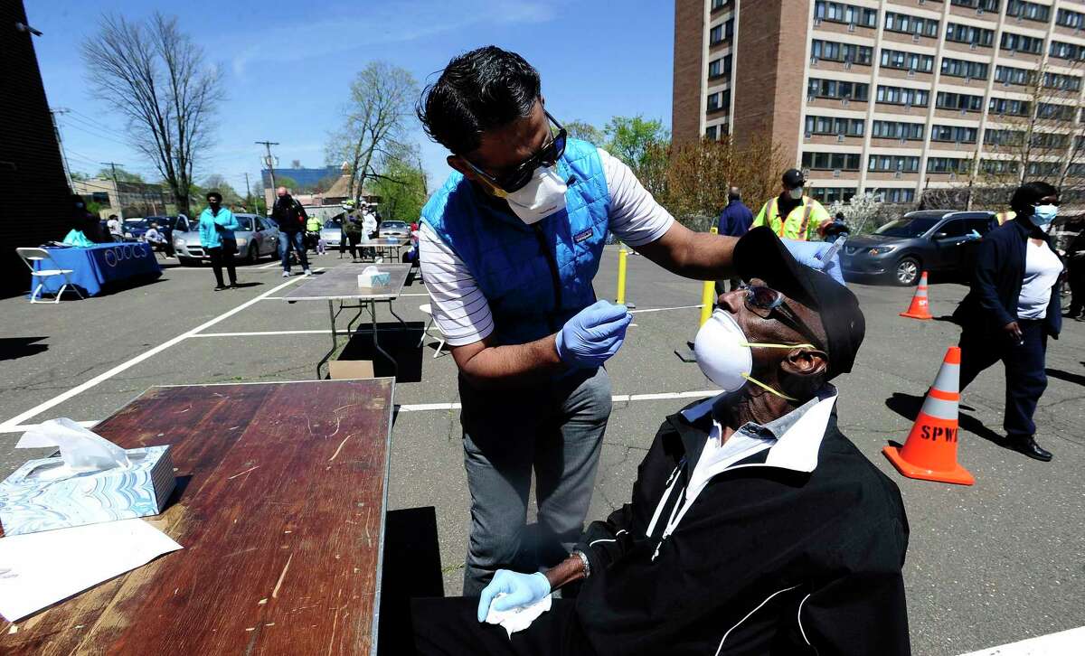Dr. JD Sidana of DOCS Urgent Care Stamford administers a COVID-19 nasal swab test on Robert Hayes, 73, of Stamford at a walk up testing site for the Coronavirus at AME Bethel Church in Stamford, Connecticut on May 2, 2020. Over 200 tests were perform by medical professinals for residents of Stamford's Westside.