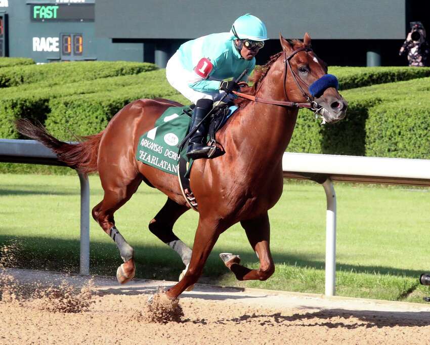 Martin Garcia, top, and eventual winner Charlatan (1) lead the field past the grandstand during the first division of the Arkansas Derby, Saturday, May 2, 2020, at Oaklawn Racing Casino Resort in Hot Springs, Ark. (Richard Rasmussen/The Sentinel-Record via AP)