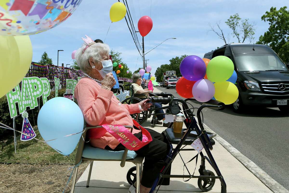 The staff at Franklin Park Senior Community surprises Irene Wilson, left, with a parade that included a San Antonio Fire Department fire truck on her 105th birthday on Wednesday, April 29, 2020.
