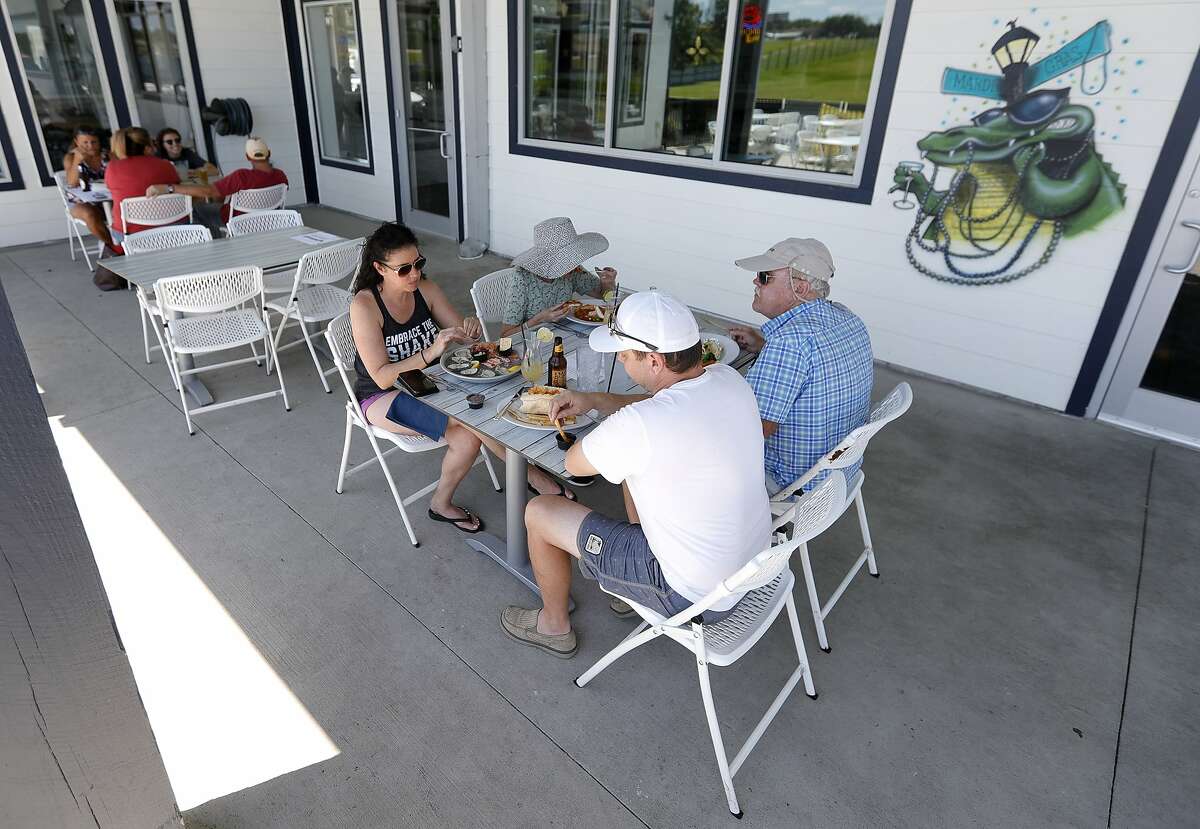Denise and James Fiore enjoy lunch with family at Monty's Lighthouse Cajun Bar & Grill, Saturday, May 2, 2020, in Montgomery. Restaurants around Montgomery County were able to reopen at 25 percent capacity after Gov. Greg Abbott’s executive order ended Thursday.