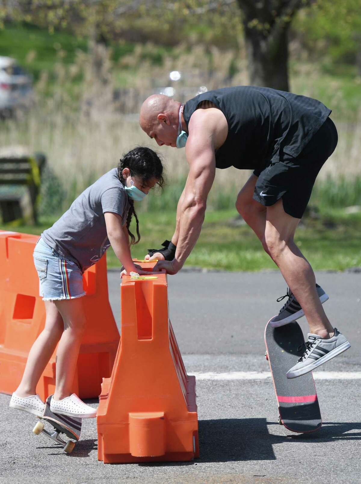 Ella Unger, 8, and Peter Unger, of Harrison, N.Y., practice ollies on their skateboards at Bruce Park on a sunny day in Greenwich, Conn. Sunday, May 3, 2020. With a high temperature in the upper-70s, the town saw lots of exhausted quarantiners active on the streets and in the parks.