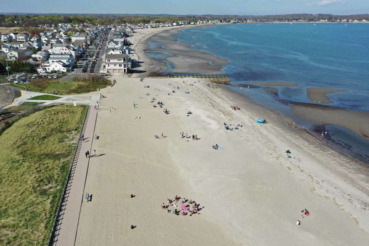 Groups of people gather Sunday at beaches in Milford, including Silver Sands State Park, which was closed to new visitors by the afternoon when the parking lot reached capacity.