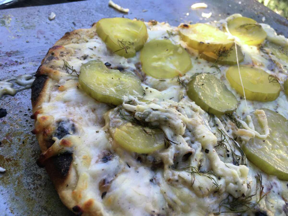 A dill pickle pizza comes off hot off the grill at Chuck's Food Shack.