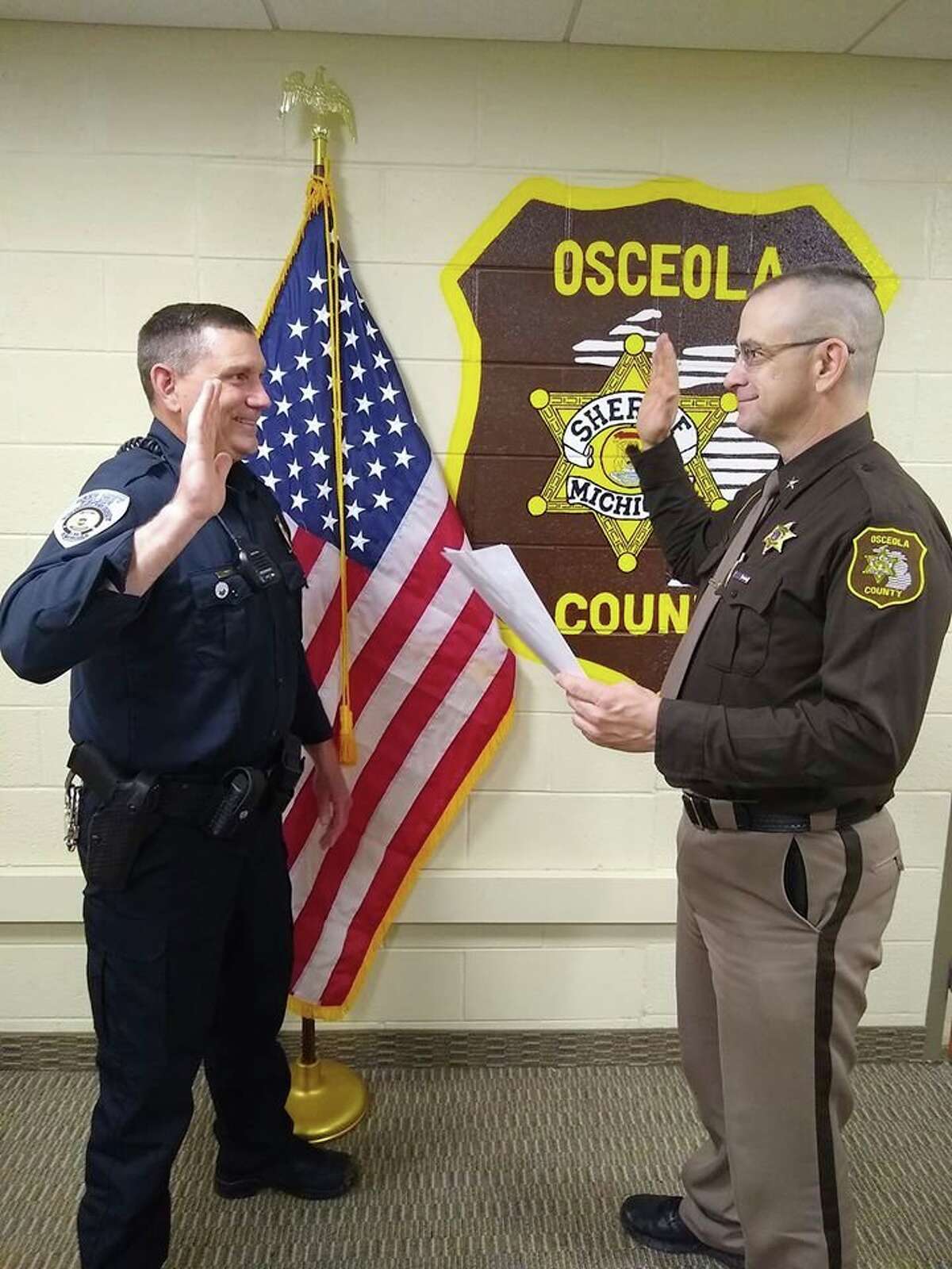 Osceola County Sheriff Ed Williams (right) deputized Reed City Chief of Police Christopher Lockhart on Friday. Lockhart said he is excited to be working in the community he grew up in. (Courtesy photo)